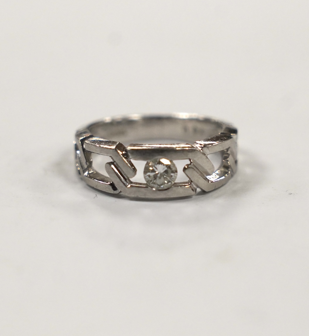 A modern pierced white metal (stamped PT900) and solitaire diamond set ring, size K, gross weight 6.7 grams.